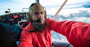Leonardo takes a moment to capture himself in his other office-- shooting photos from a doorless aircraft