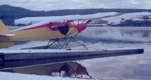 First snowfall covers a Piper PA-12 at the Eagle Lake base