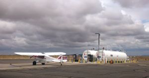 The Super Cub parked against yet another background of uncertain sky and fuel tanks